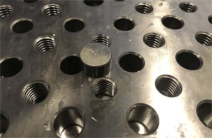 The density of the threaded holes on the fixture plate